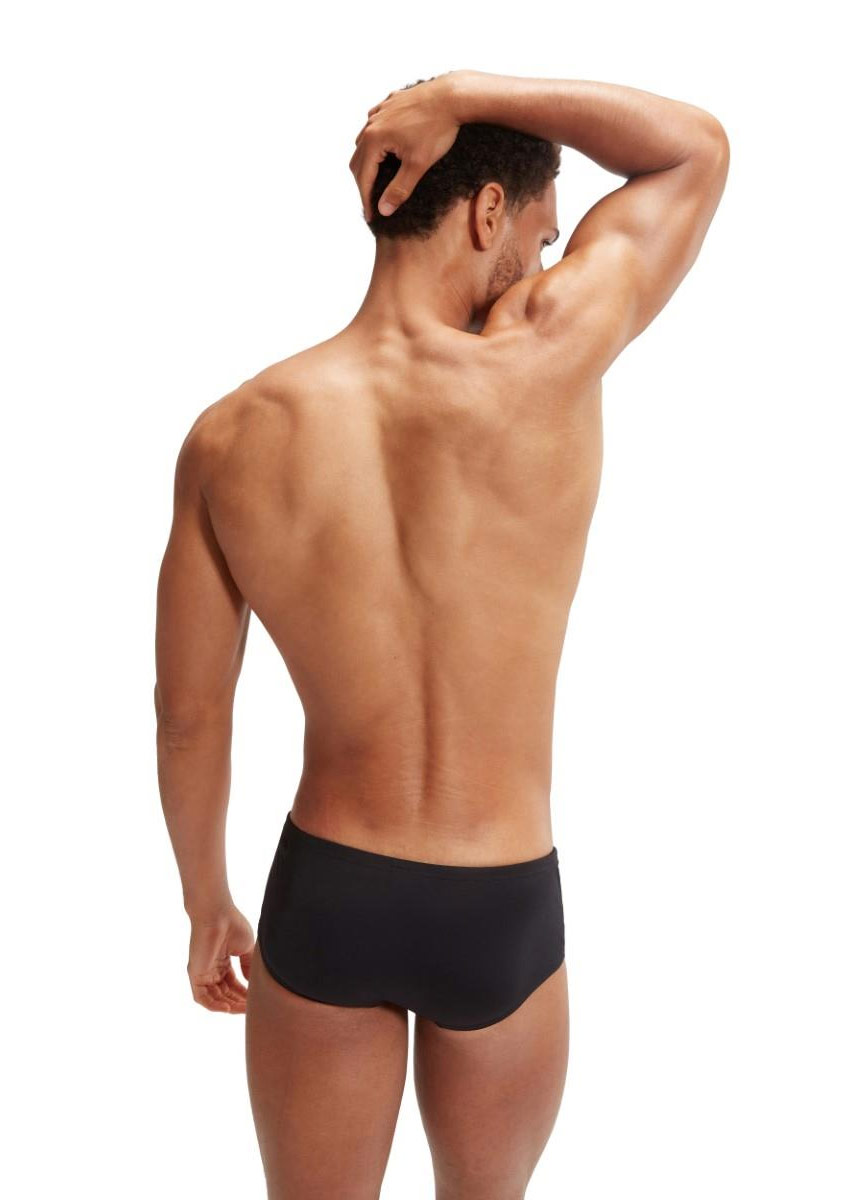Man wearing Speedo Allover Digi 14 cm Brief - Black / Purple with hands folded over the head