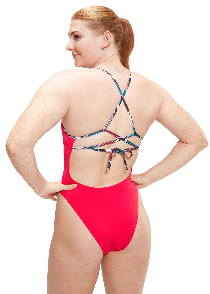 Lady smiling wearing Speedo Solid Lattice Tie-Back Swimsuit - Red / Blue