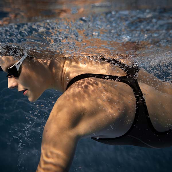 woman swimming in pool wearing arena powerskin impulso kneesuit